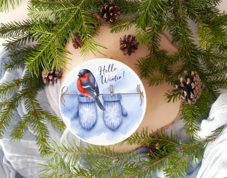 Knitted woolen mittens drying on a string. Bullfinch sitting on a string. Christmas, Winter, New Year decoration. Watercolor hand-painted clipart.